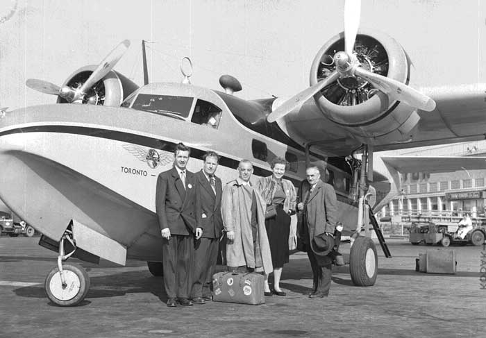 Globe and Mail staff standing outside of aircraft