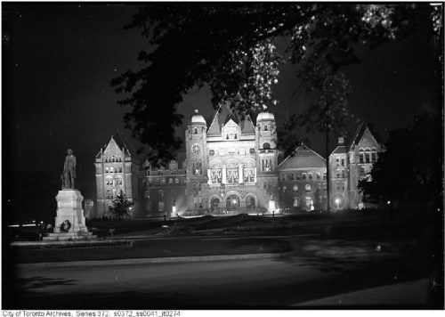 Queen's Park buildings lit up by spotlights.