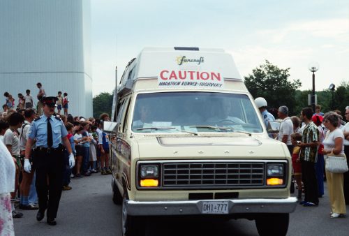 Picture of the Terry Fox Marathon of Hope van outside Scarborough Civic centre with a police officer beside it and a crowd around it