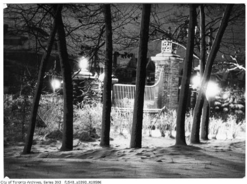 Stone pillars and metal gates in the snow.