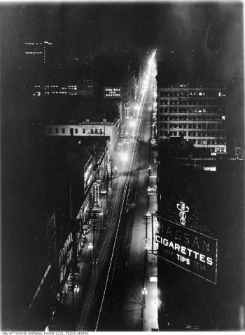 Looking along Yonge Street at night, with all the lights making bright lines on either side.