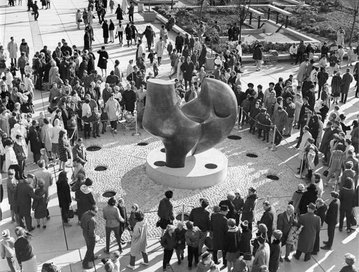 Crowds surround large outdoor abstract sculpture
