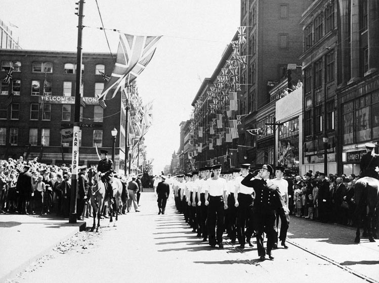 Sailors march in formation along Queen Street.