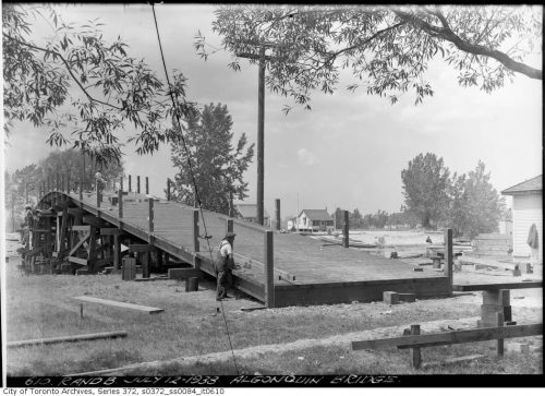 Black and white photograph of the Algonquin Island bridge surrounded by trees.