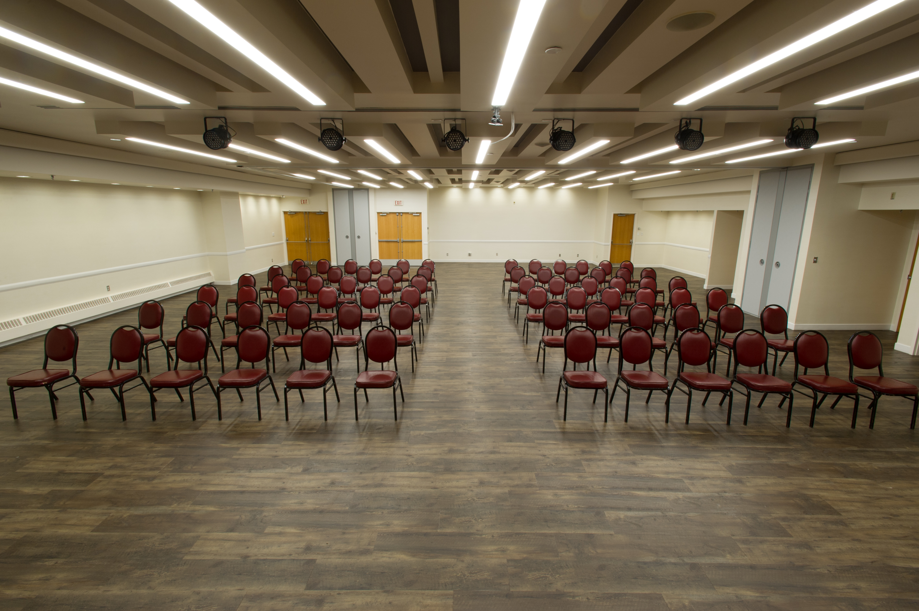 Memorial Hall Burgundy Room with theatre-style seating, which includes two sections of chairs facing the same direction and an aisle down the centre and sides of each set of chairs.