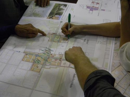 Photo of people pointing to a map during the September 28, 2017 public meeting.