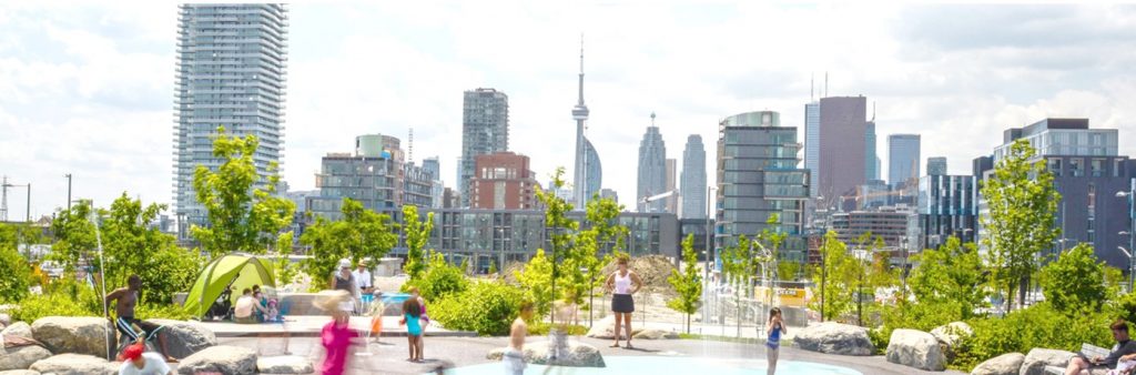 View of Corktown Common splash pad looking east to downtown Toronto