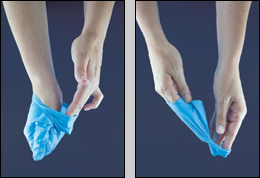 hands removing a latex glove. Reach under the second glove and peel away.