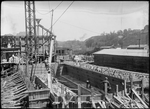 Chute directing concrete into large oval form.