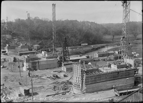 View over valley showing large oval concrete piers being built.