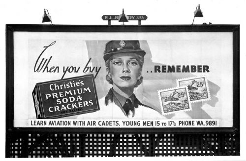 Billboard showing woman in armed forces uniform.