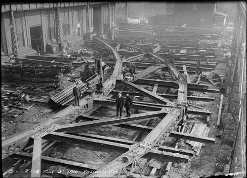 Riveted metal arch laid on the ground.