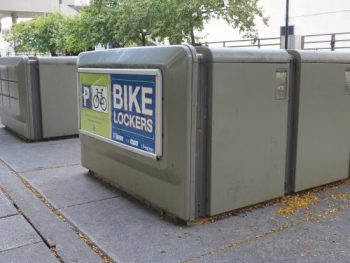 Two rows of grey bicycle lockers at City Hall