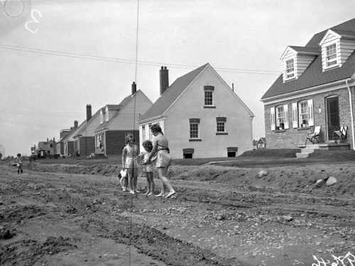 Small wartime houses and unpaved road