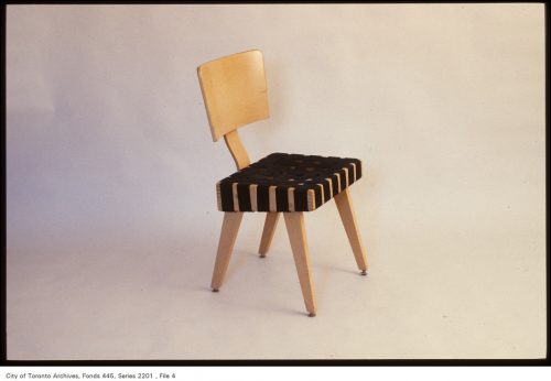 Blonde wood chair with black webbing seat.