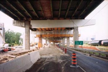 Road under construction underneath elevated expressway