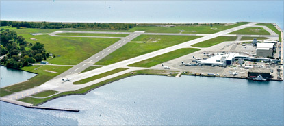 Sky view of Billy Bishop Airport, showing the runway and surrounding water