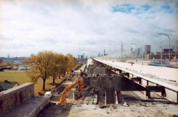 Looking into distance along old concrete support pillars with deck of expressway gone