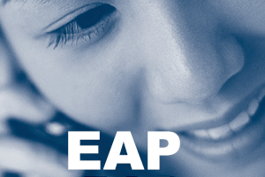 A cropped photo of the City of Toronto's EAP brochure, which has a woman smiling and holding a telephone receiver to her ear