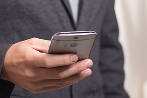 A close-up photo of a person holding a cell phone.