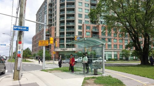 Image of green space, sidewalk, bike lanes and accessible covered bus stop in Scarborough