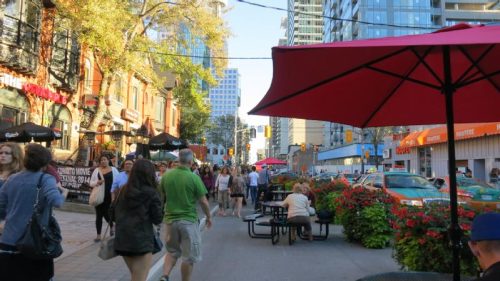 Image of John street sidewalk-café-like seating area surrounded by flowers