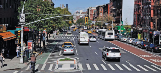 Image of street with bike lanes, bus lanes, parking and vehicles