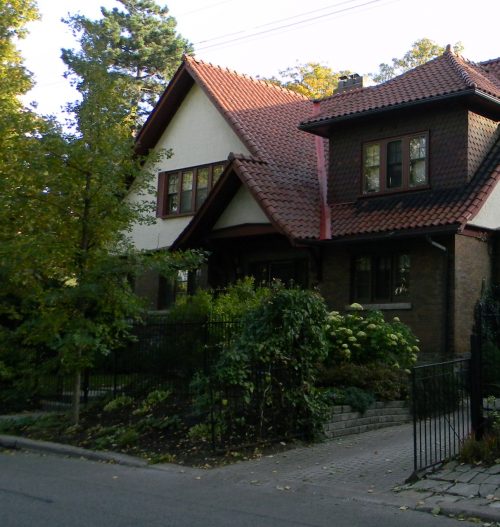 A two-storey house with a steep red-tile gable roof.