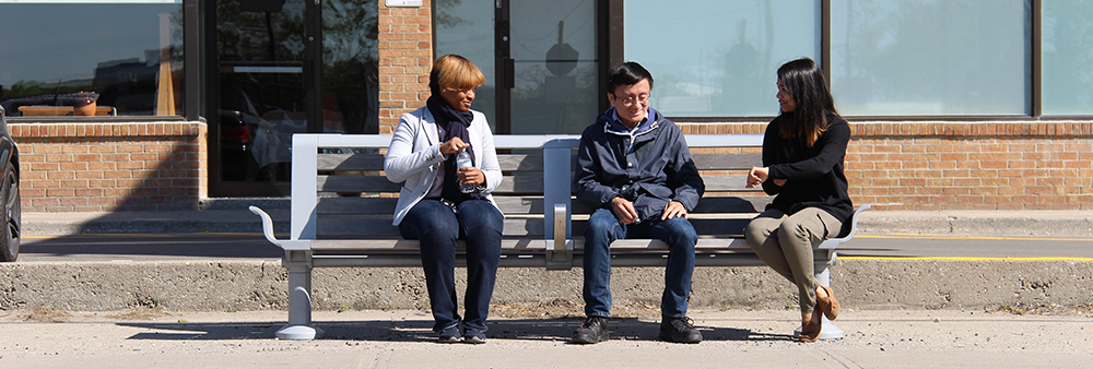 Image of three people sitting on a bench