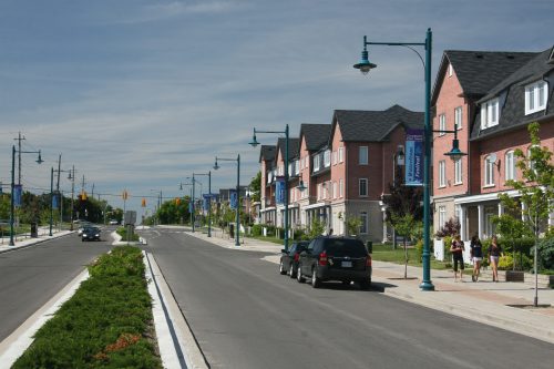 Image of Suburban Street in Port Union. Shows two cars parked on one side of the street and a planted road median.