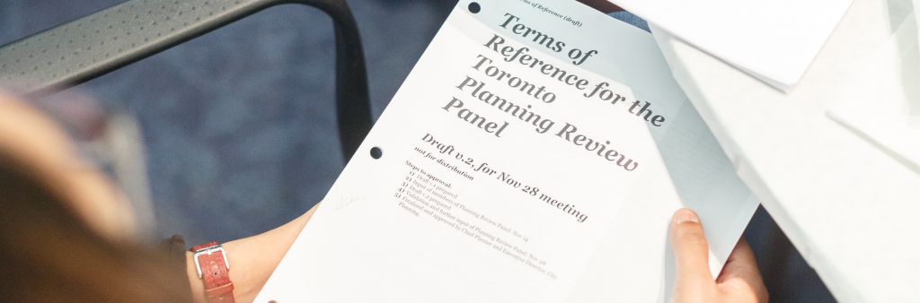 A Panelist holds a draft of the Planning Review Panel Terms of Reference in her hands