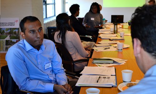 Image of youth sitting around a table for a presentation