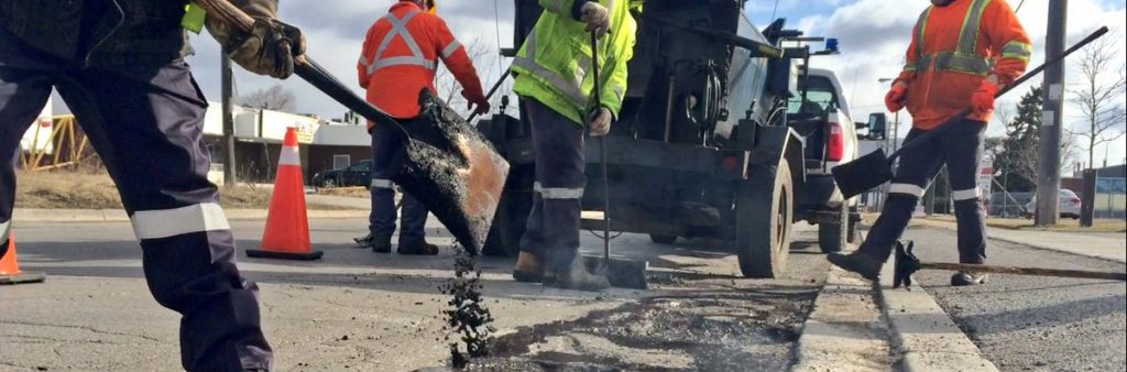 Image of City crews filling a pothole