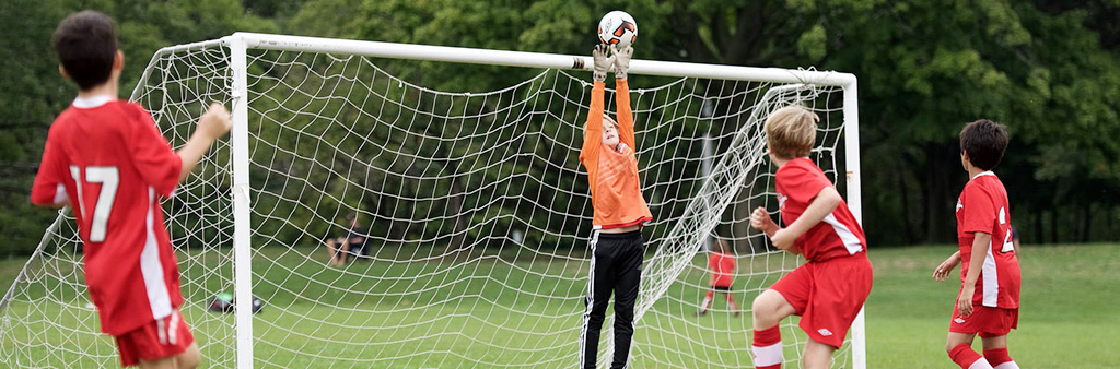 Kids playing football in high park