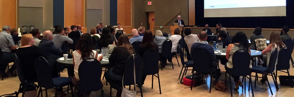 People watching presentation at a town hall meeting