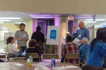 Attendees discussing question 1 in a circle
