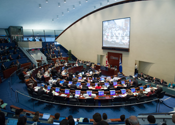 Interior of City Council Chambers at Toronto's City Hall showing seating for Councillors and seating in the public gallery