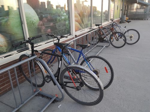 A bicycle rack that only provides space for locking the wheel and not the frame. The 4 bikes in this photo are using the exterior of each rack to lock their frames.