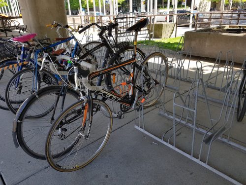 bicycle locked up to a multi-bike rack. These racks provide space to secure the bike and lock the frame