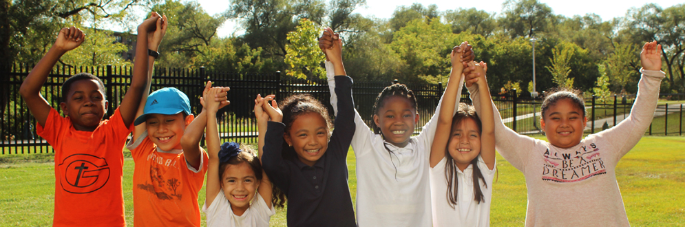 seven children holding hands outside