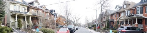 A residential street lined with very similar looking two-and-a-half-storey Edwardian houses.