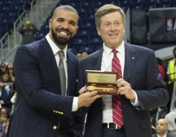 Mayor John Tory presenting Drake a Key to the city at a Toronto Raptors game in the Air Canada Centre.