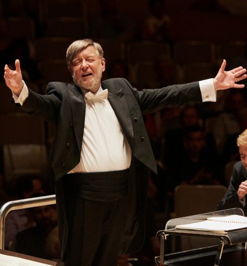 Conductor with arms wide spread. Image info: Sir Andrew Davis. Credit: Malcolm Cook.