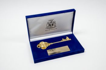Gold key to the city in a blue and white box