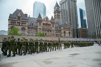 Canadian Armed forces regiment marching on Nathan Philips Square towards Toronto City Hall as they receive their Freedom of the City honour.