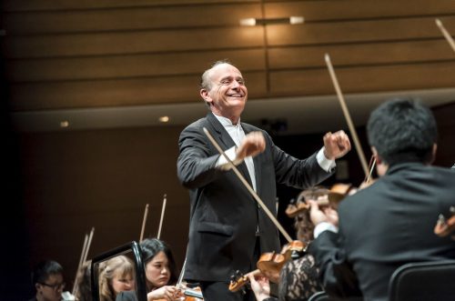 Image info: Gábor Takács-Nagy. Conductor and strings section of orchestra.