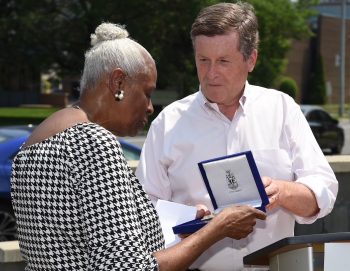 Mayor John Tory hands Pat Moore her key to the City in Throncliffe.