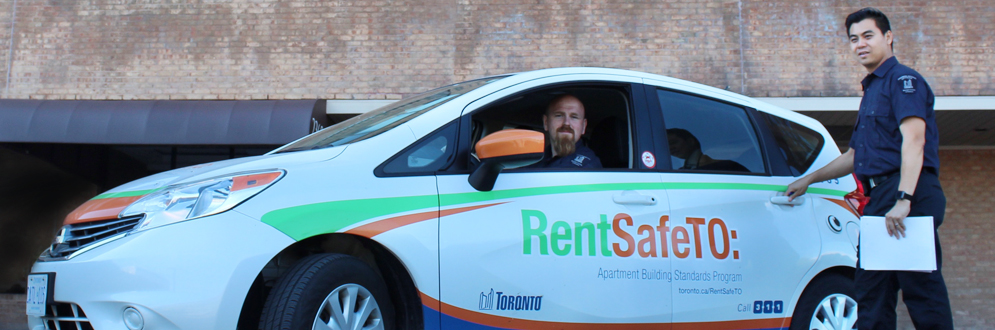 City of Toronto officers going into their vehicle to conduct an inspection of an apartment building