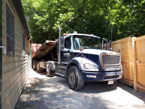 truck inside Rosehill hoarding near ravine and Avoca