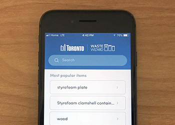 TOwaste mobile application shown on the screen of a smartphone